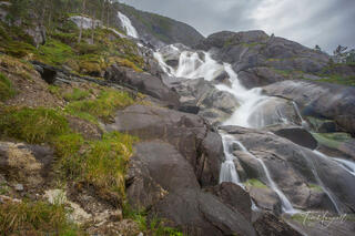 View from the upper hiking trail at Langfoss Waterfall in Haugesund, Norway, captured on a rainy day after a strenuous uphill trek.
