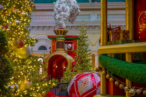 Bellagio Conservatory Christmas decorations featuring a large illuminated Christmas train and holiday ornaments in Las Vegas