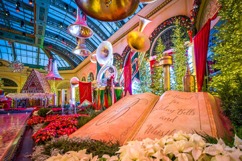 Bellagio Conservatory Christmas display with festive characters, holiday trees, and decorative lighting