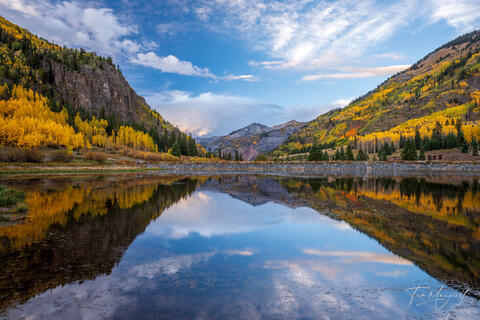 Fine art landscape photograph of a calm mountain lake reflecting golden aspens and rugged peaks along the Million Dollar Highway near Silverton, Colorado.